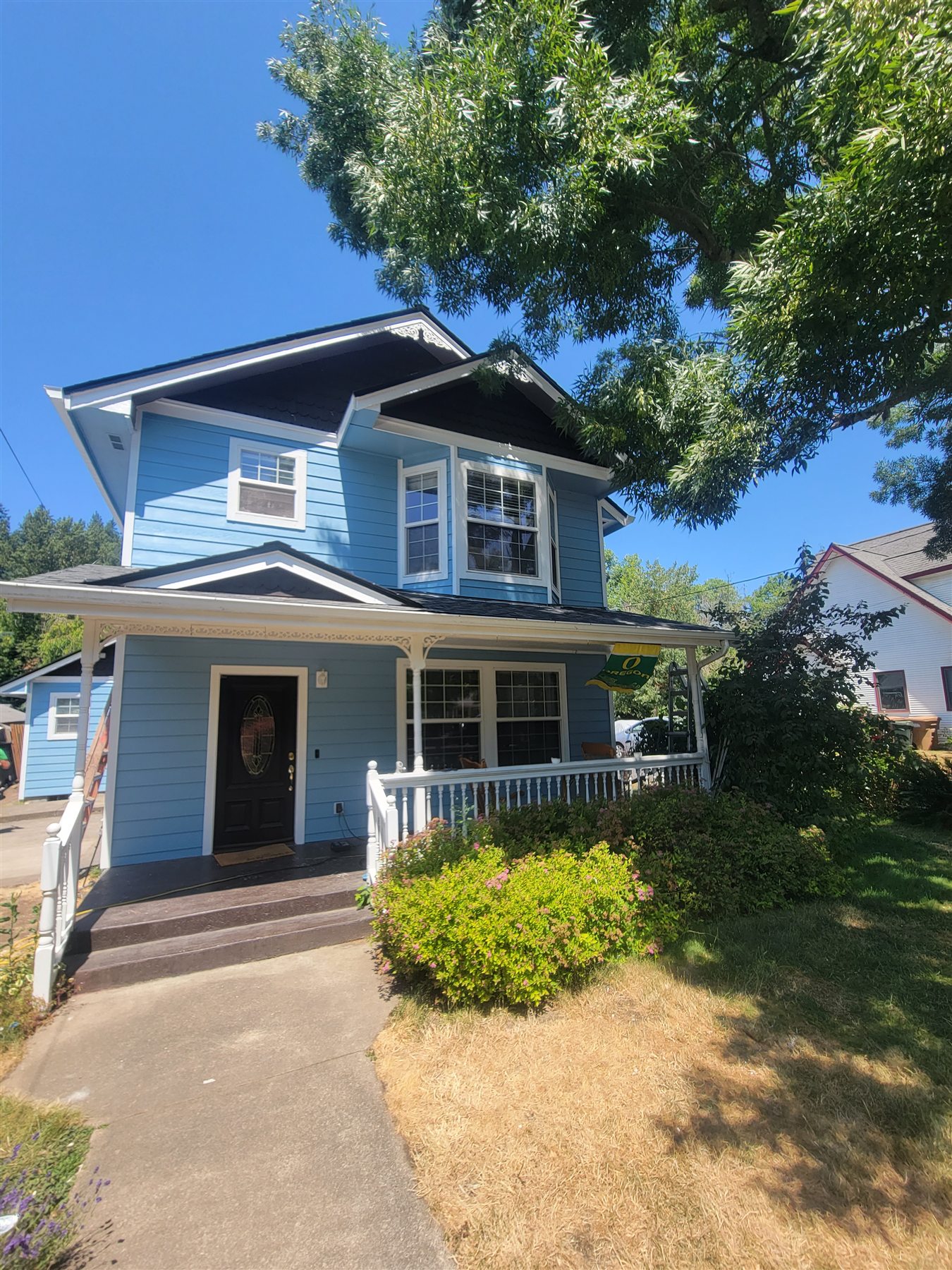 Blue two-story home showing Premier G.F.P. gutter, siding, and exterior paint work in the Eugene and Springfield service area